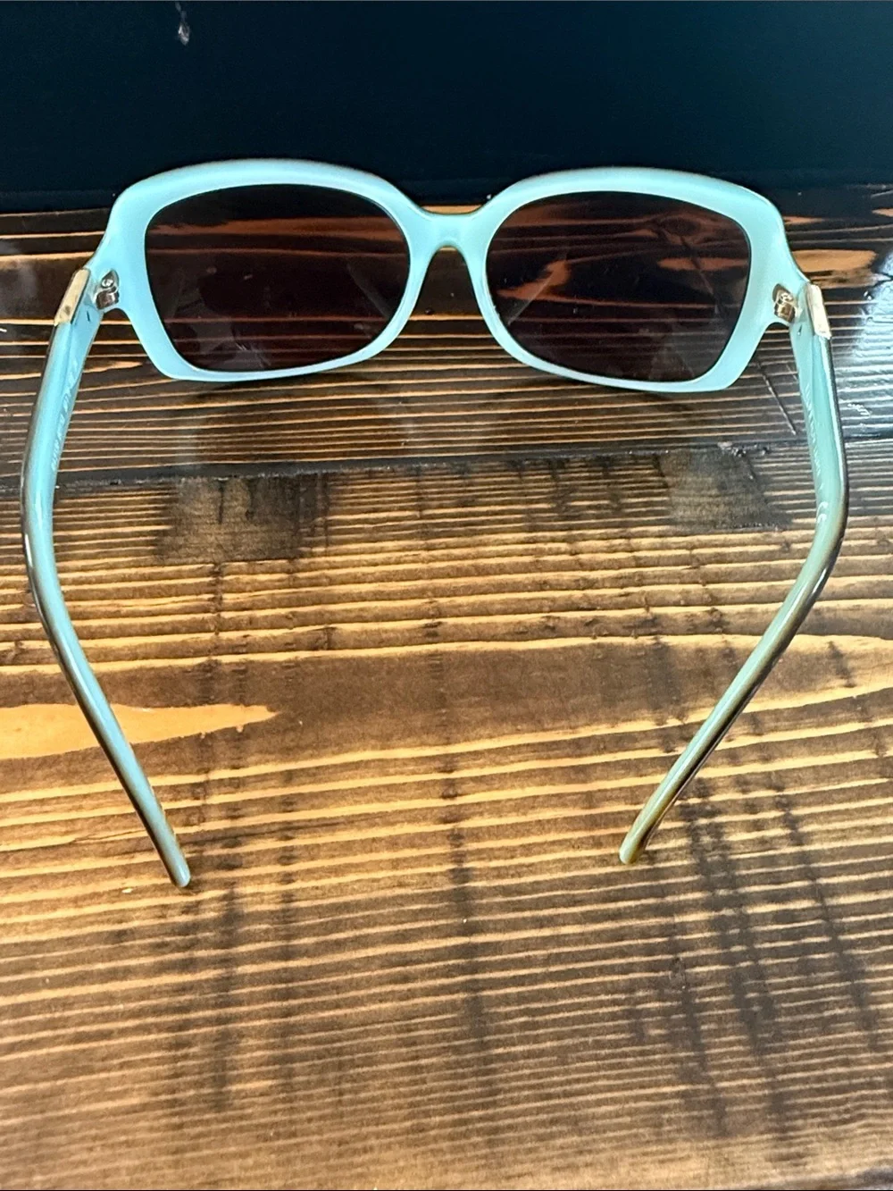 Ralph Lauren sunglasses feature a teal frame and tortoise-shell temples. Frames